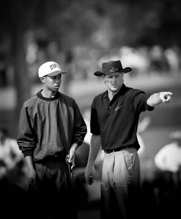 Tiger Woods getting advice from Greg Norman
