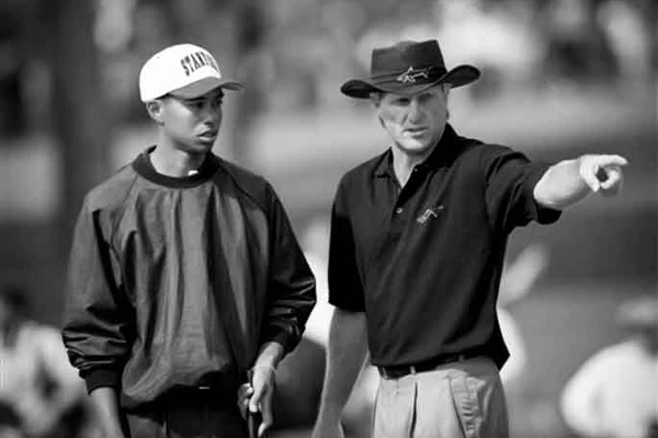 Tiger Woods getting advice from Greg Norman